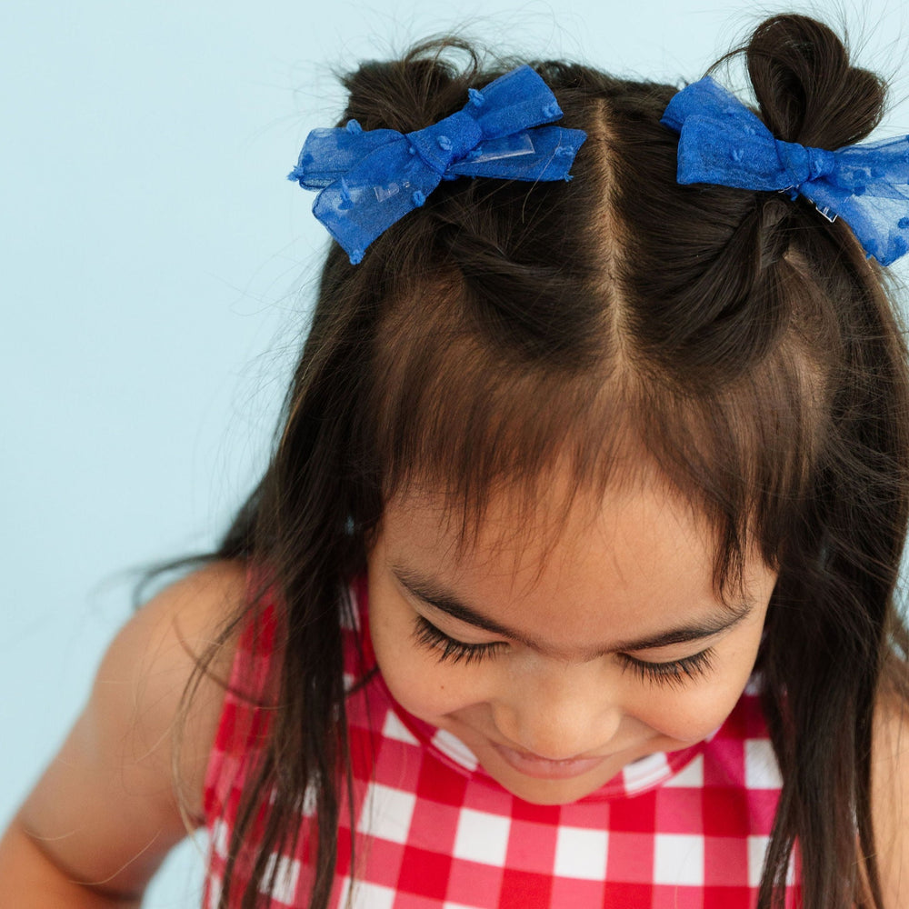 little girl wearing sheer pigtail bows in cute mini buns 