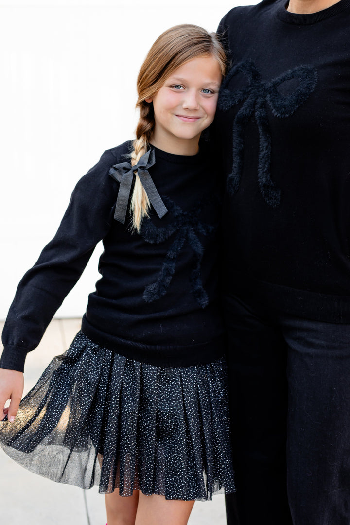 mama and little girl in matching black sweaters with fluffy black bows design for Halloween