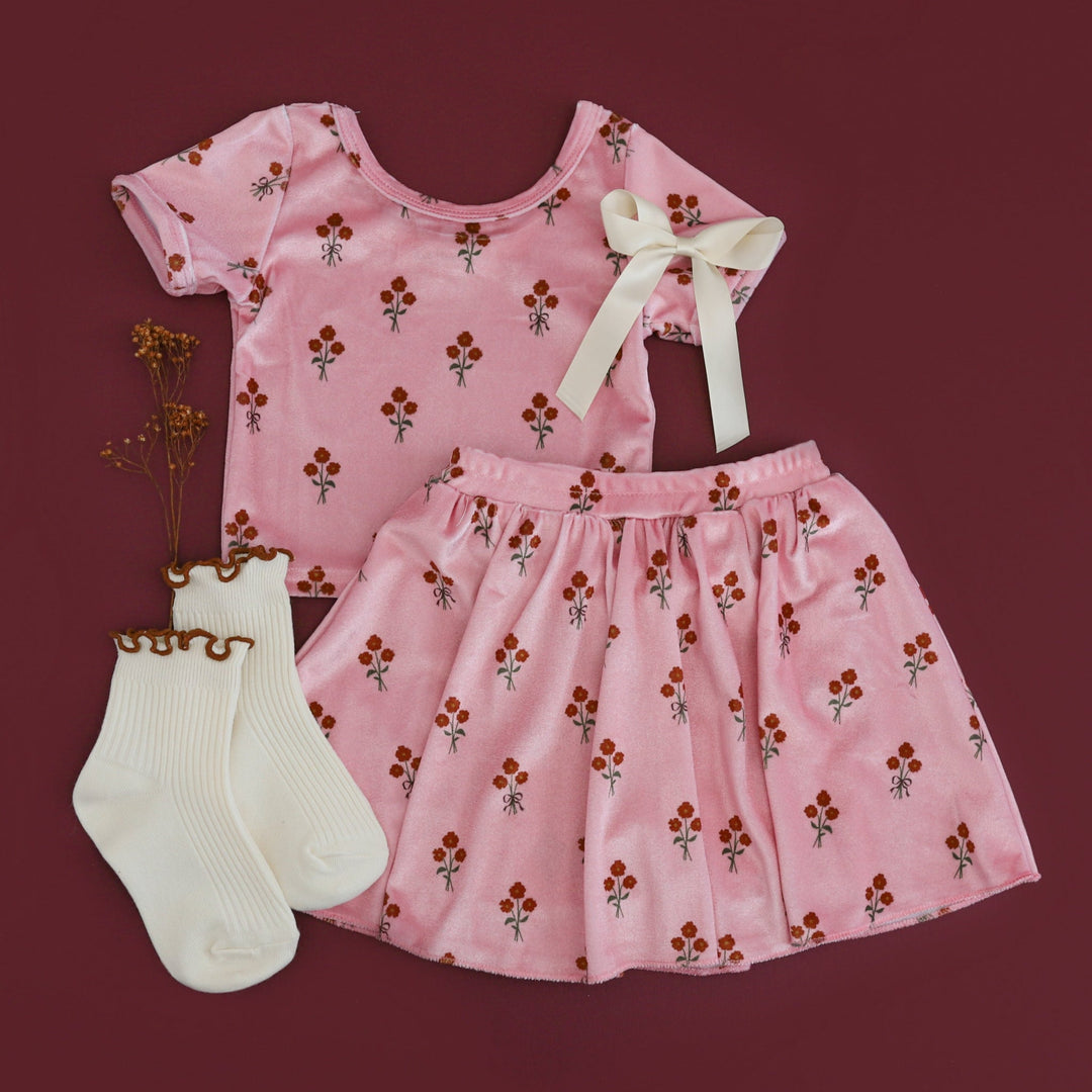 girls' pink velvet short sleeve top and matching skort with petite fall floral pattern paired with ivory lettuce trim midi socks and satin hair bow