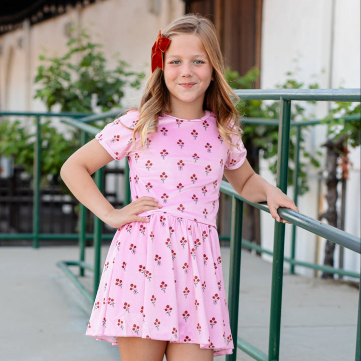 little girl in pink velvet floral fitted top with rust fall floral print, ivory midi socks with rust ruffled trim and pumpkin spice velvet ribbon hair bow