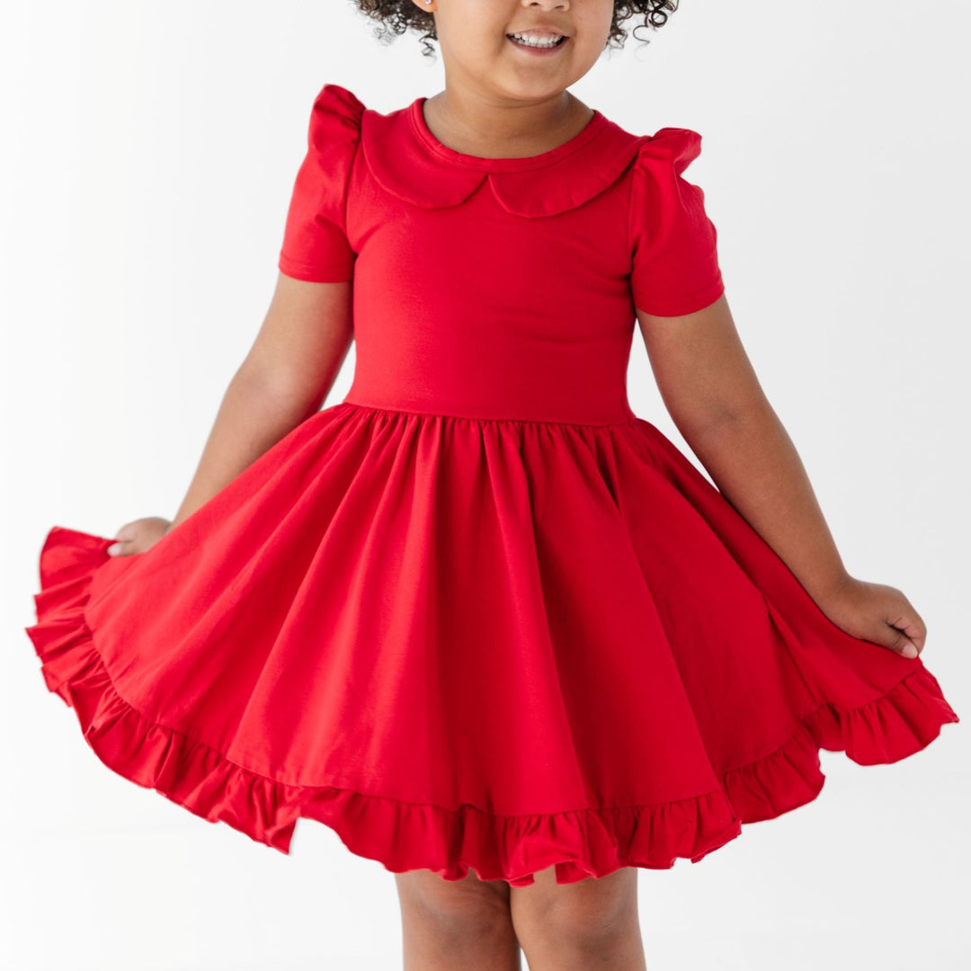 little girl in bright red cotton blend twirl dress with short puffed sleeves, ruffle hem and collar for back to school