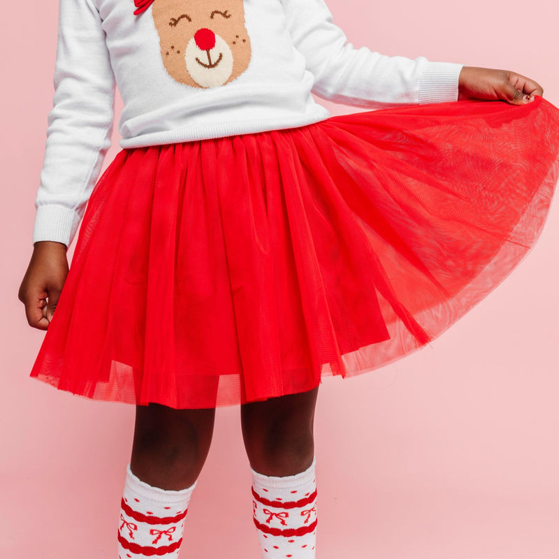 closeup of little girl in bright red tulle skirt to match rudolph outfit