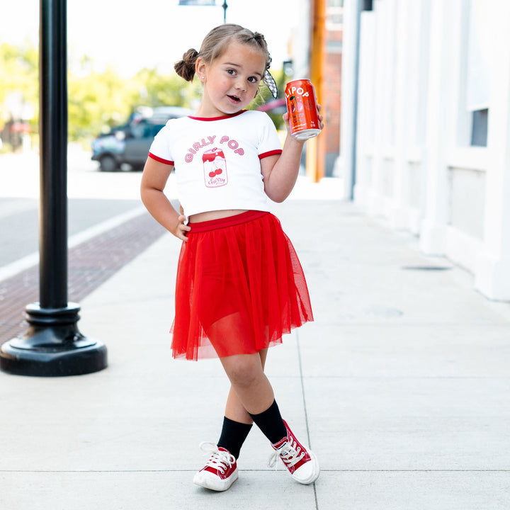 little girl in red tulle skirt with built in biker shorts paired with white "Girly Pop" tee with red binding for 4th of July and summer