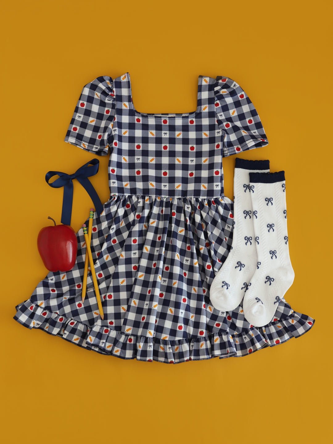 girl's navy gingham back to school themed dress with matching white knee highs with navy bow print and navy blue satin bow