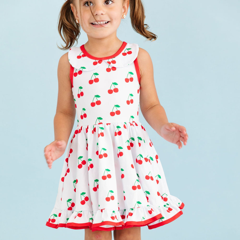 little girl wearing cherry print summer tank top dress