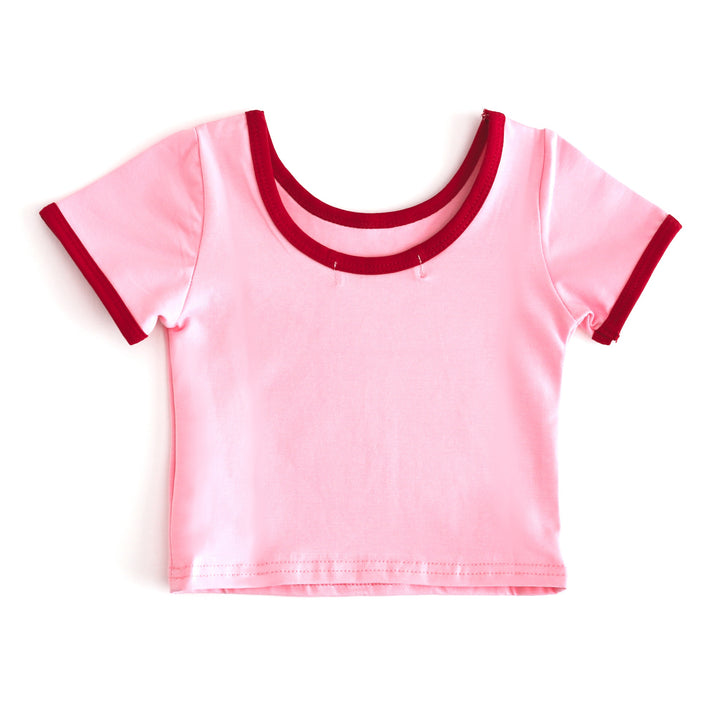 back view of scoop neck t-shirt in pink with red binding for girls