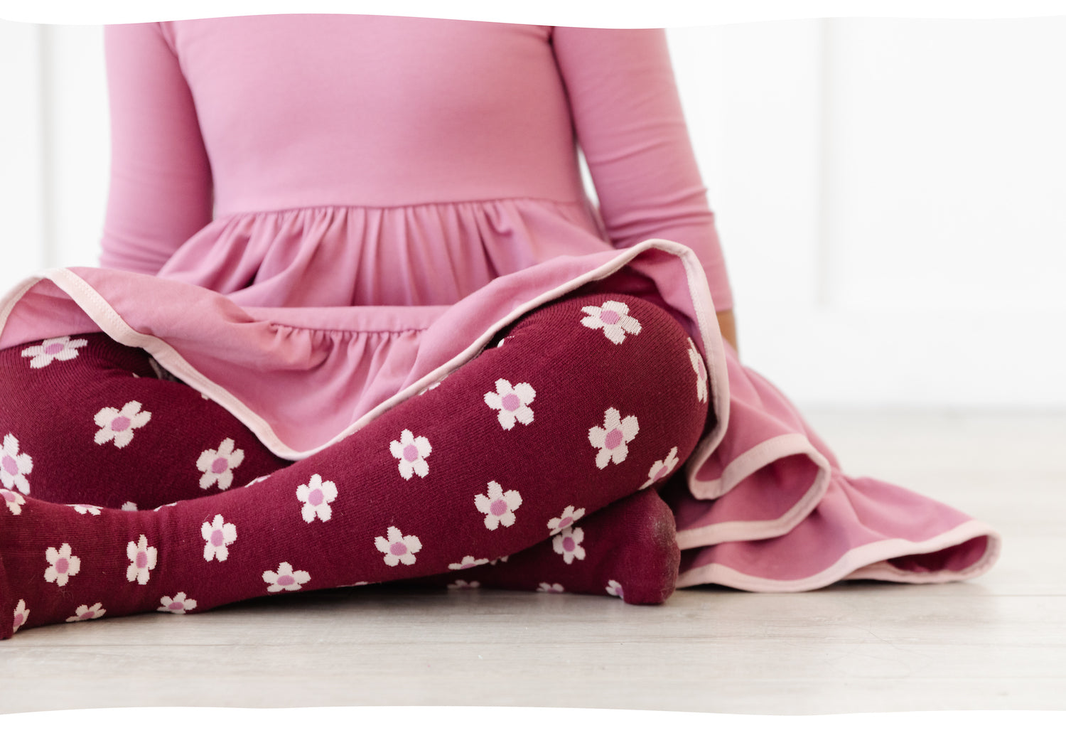 girl sitting cross legged wearing pattern floral tights