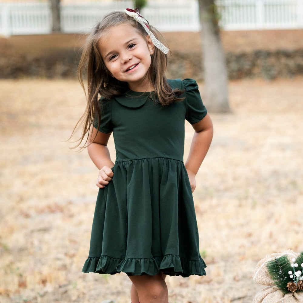 little girl in forest green, cotton blend, short sleeve twirl dress with collar and coordinating lace and ribbon bow for Christmas