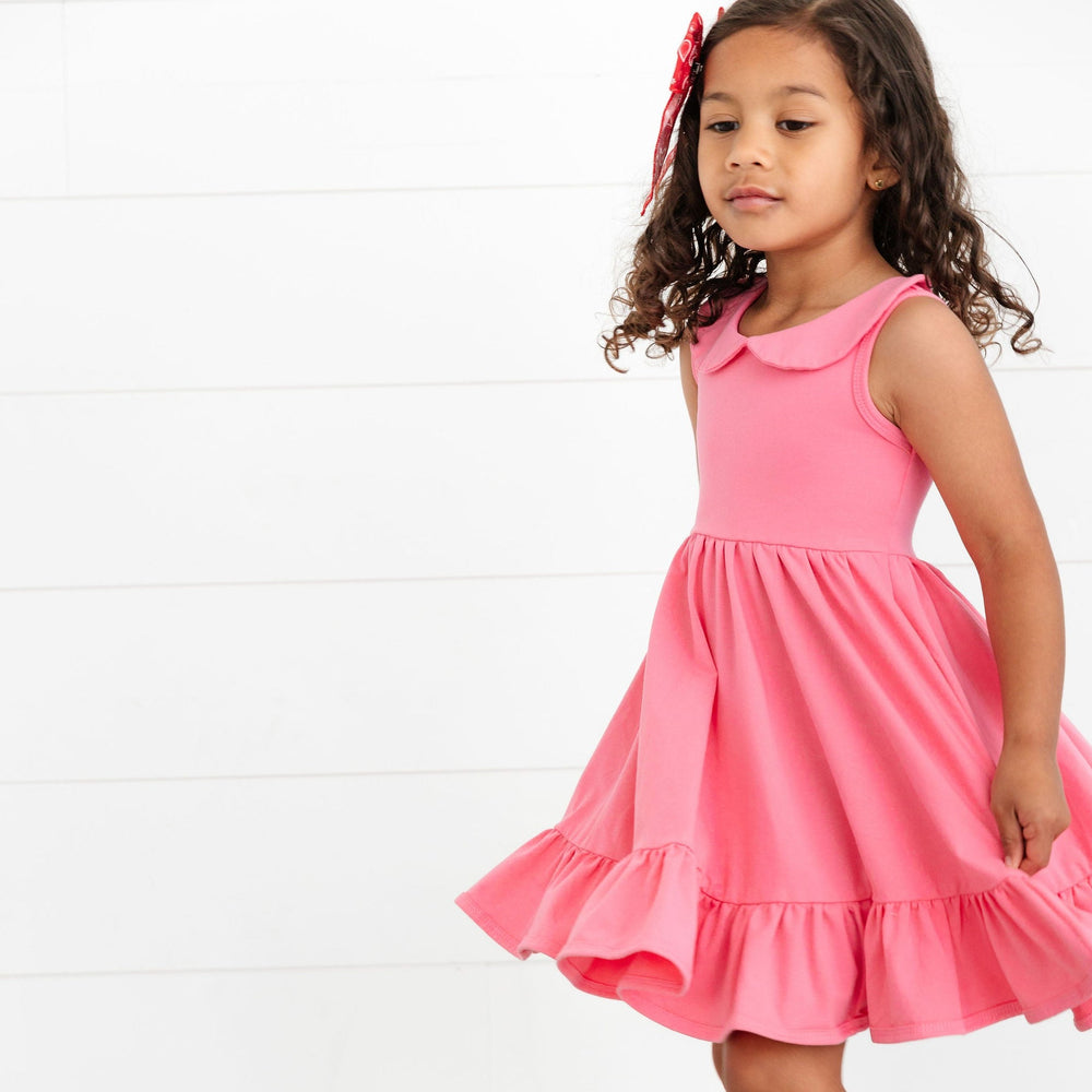 little girl twirling in fruit punch pink cotton summer dress