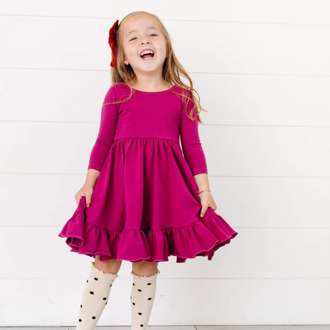 girls magenta twirl dress with pockets paired with polka dot knee high socks