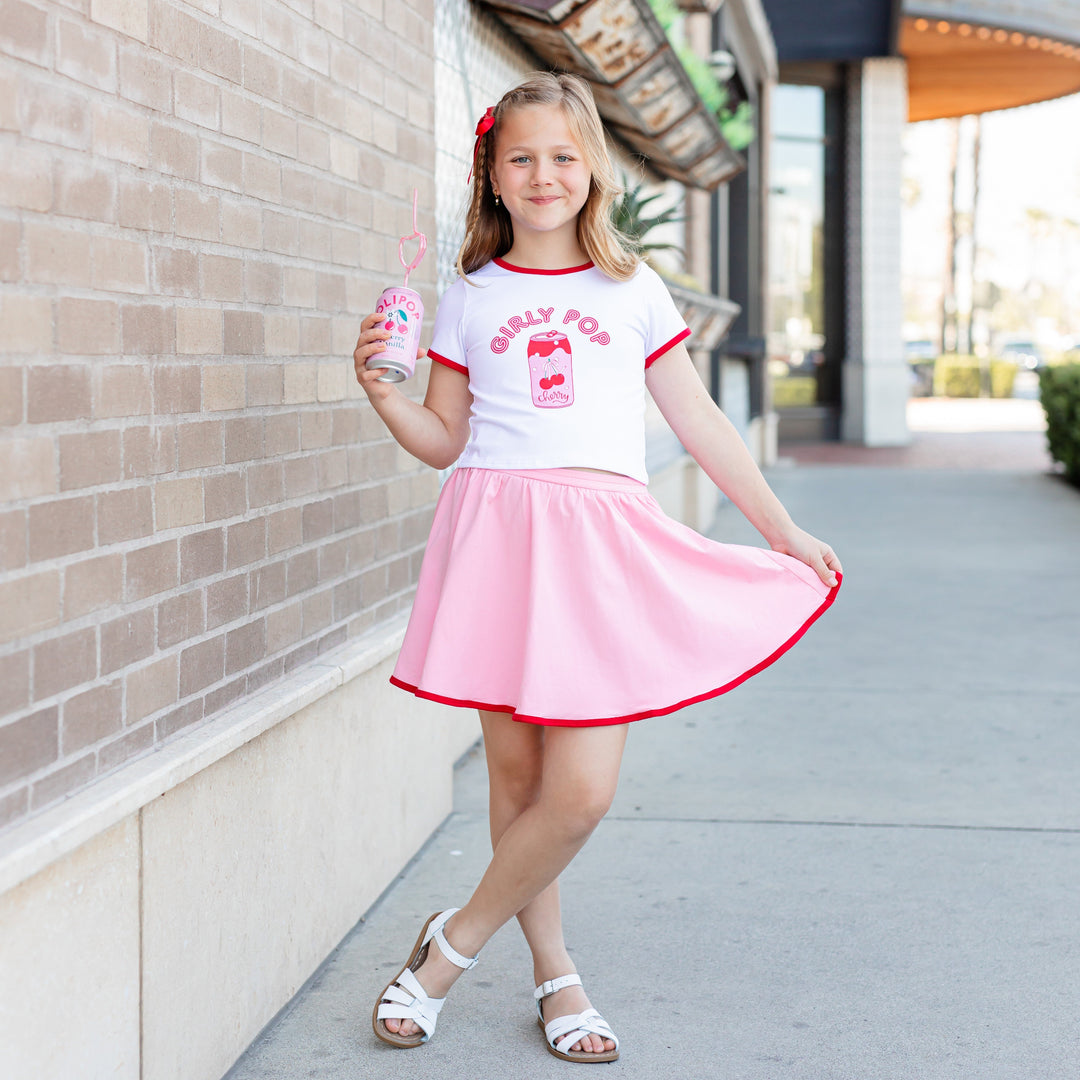 little girl in tee with cherry soda "Girly Pop" design and matching pink skort with red trim for summer