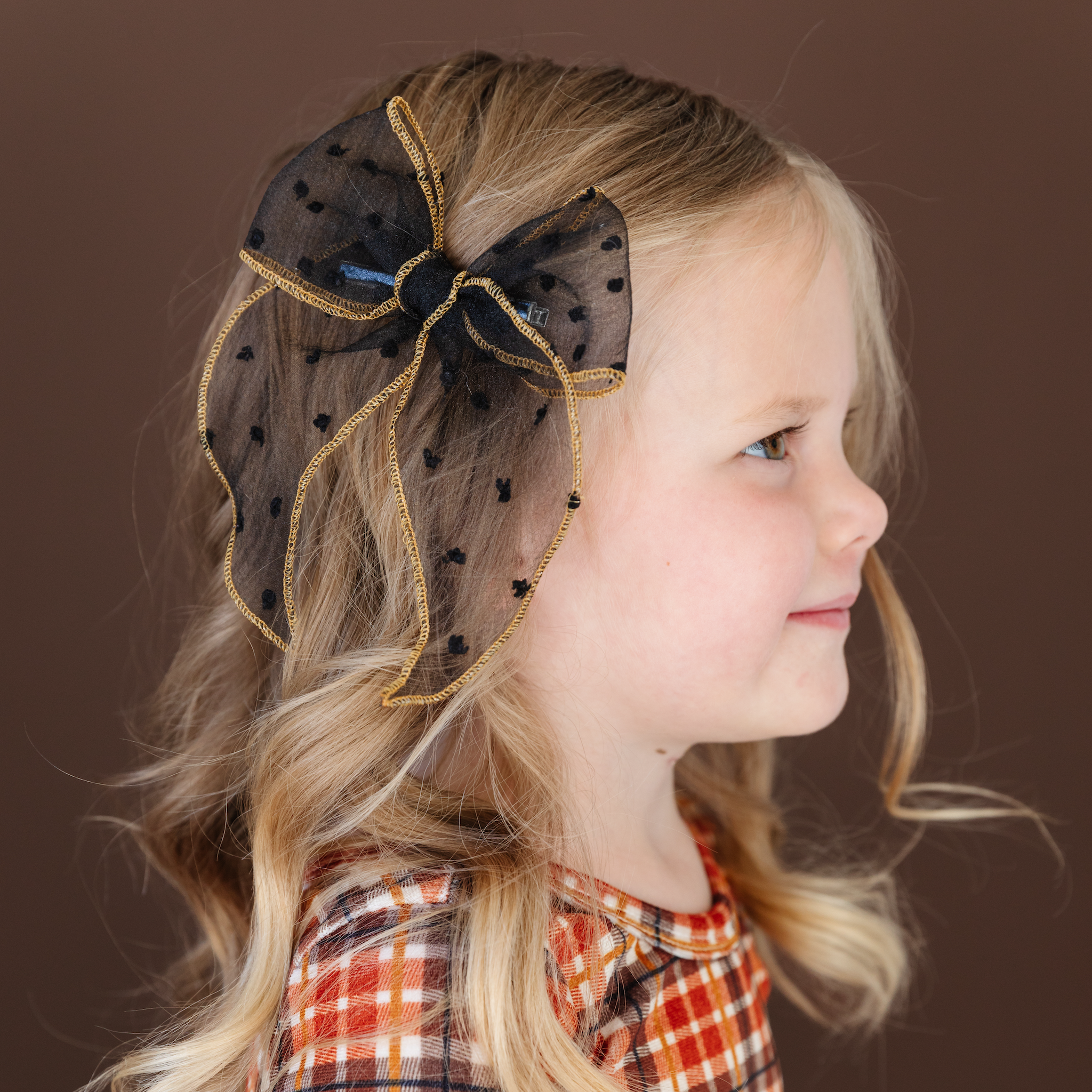 little girl with harvest outfit and black sheer dot bow with gold edging