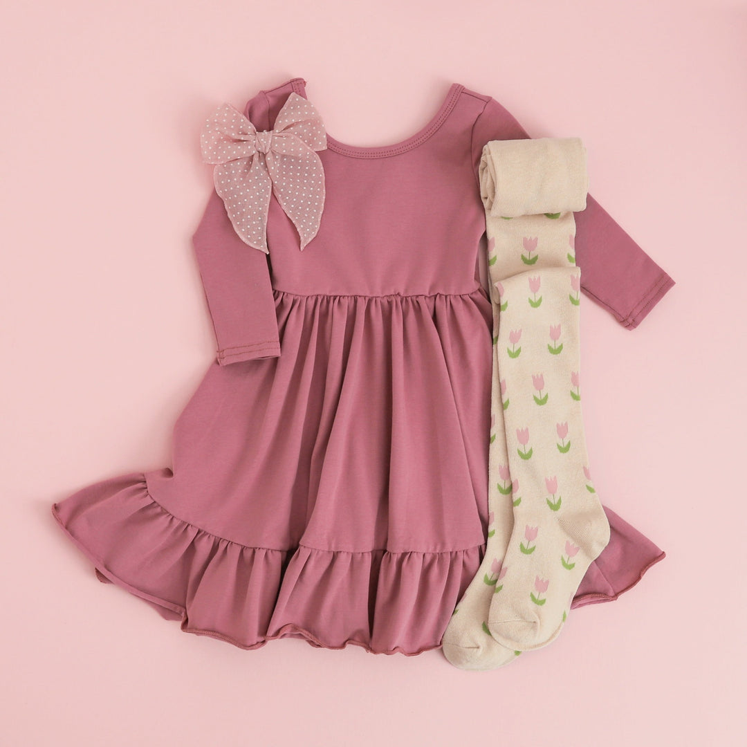 girls mauve pink long sleeve cotton dress paired with blush dot hair bow and tulip pattern tights