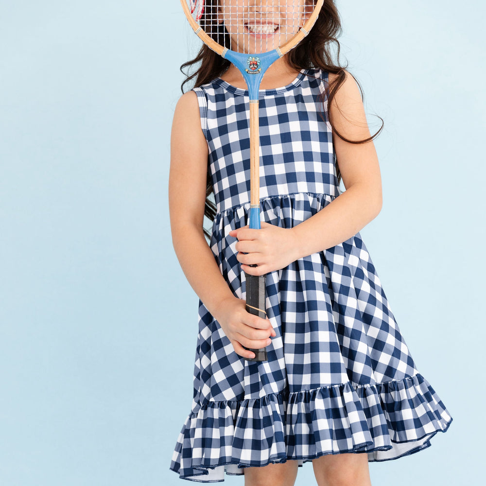 navy/white gingham picnic plaid summer dress on little girl hodling badminton racquet