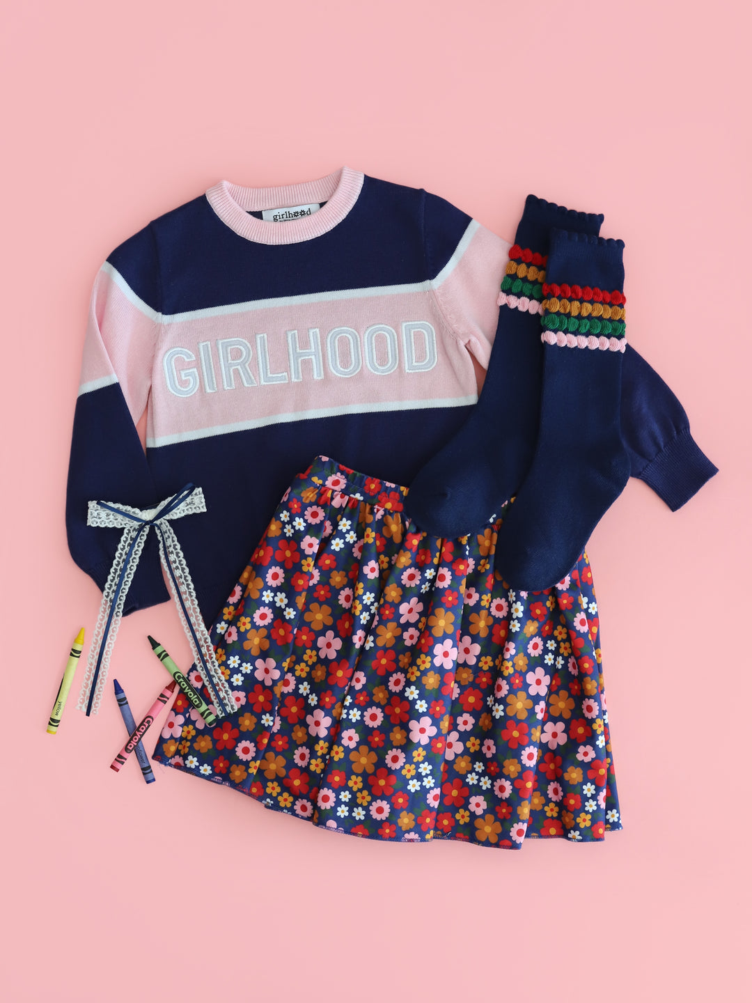 girl's navy and pink cotton girlhood pullover paired with back-to-school floral skort, navy bubble knee highs and navy blue lace bow