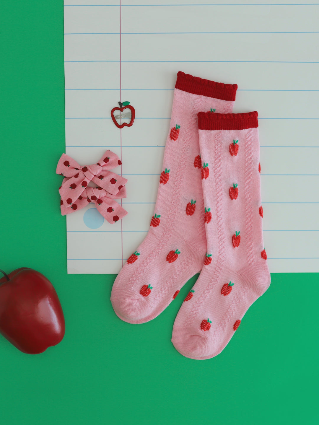 little girl's apple themed accessories featuring pink apple knee highs, pink apple pigtail bows and apple barrette to match back to school outfits
