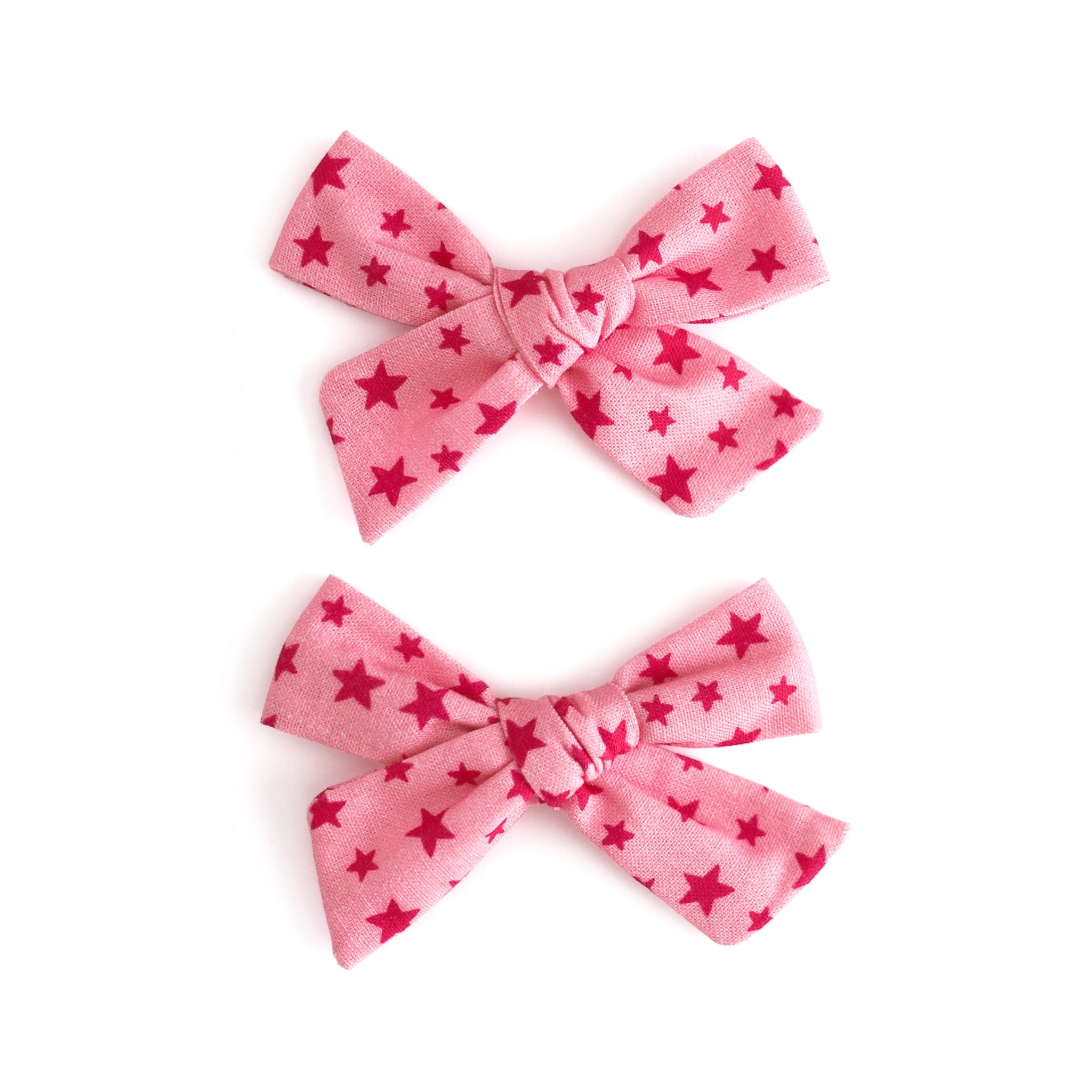 little girl's pink pigtail bows on clips with pink star print