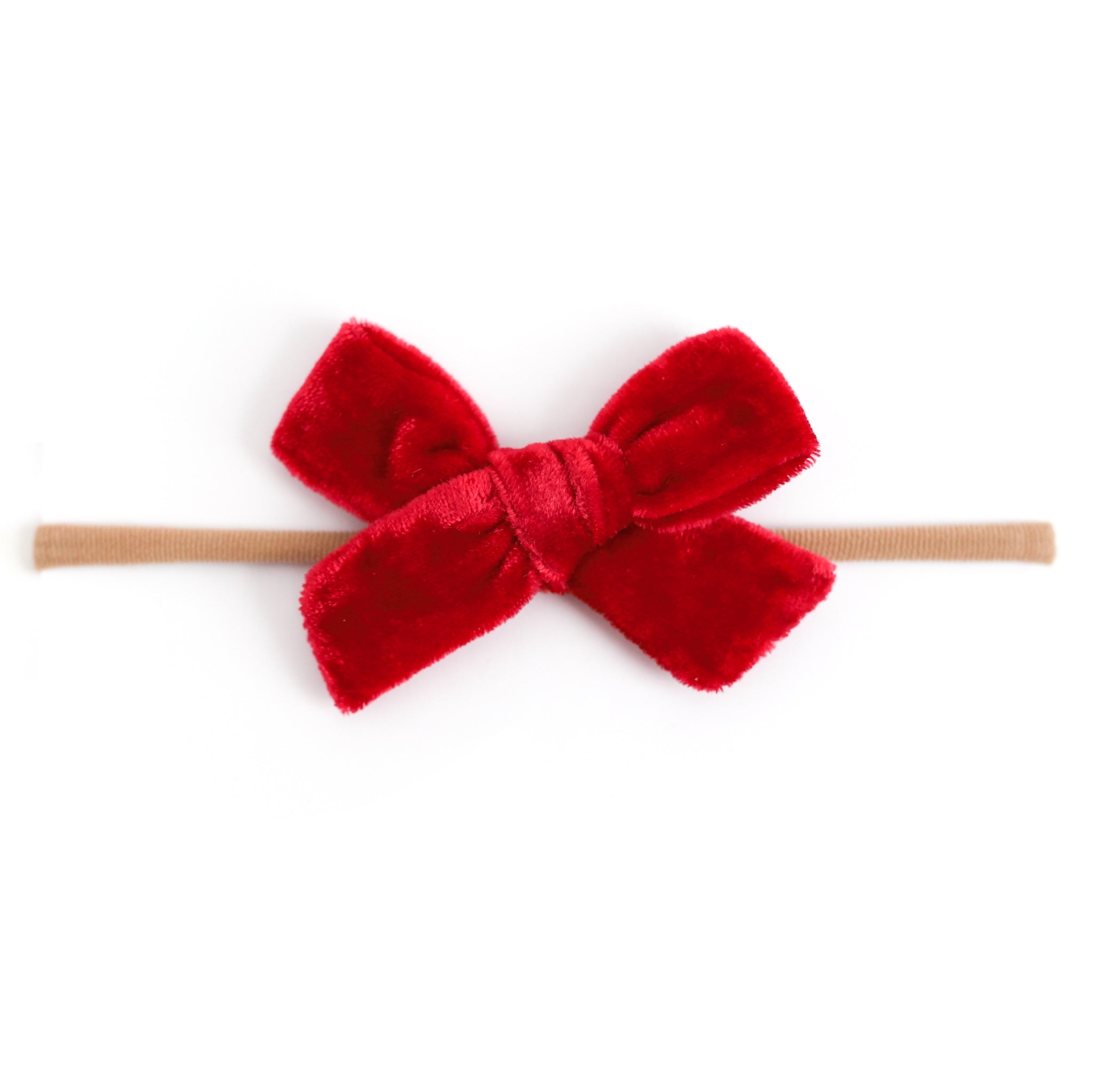 Red velvet bow on soft nylon band for baby girl