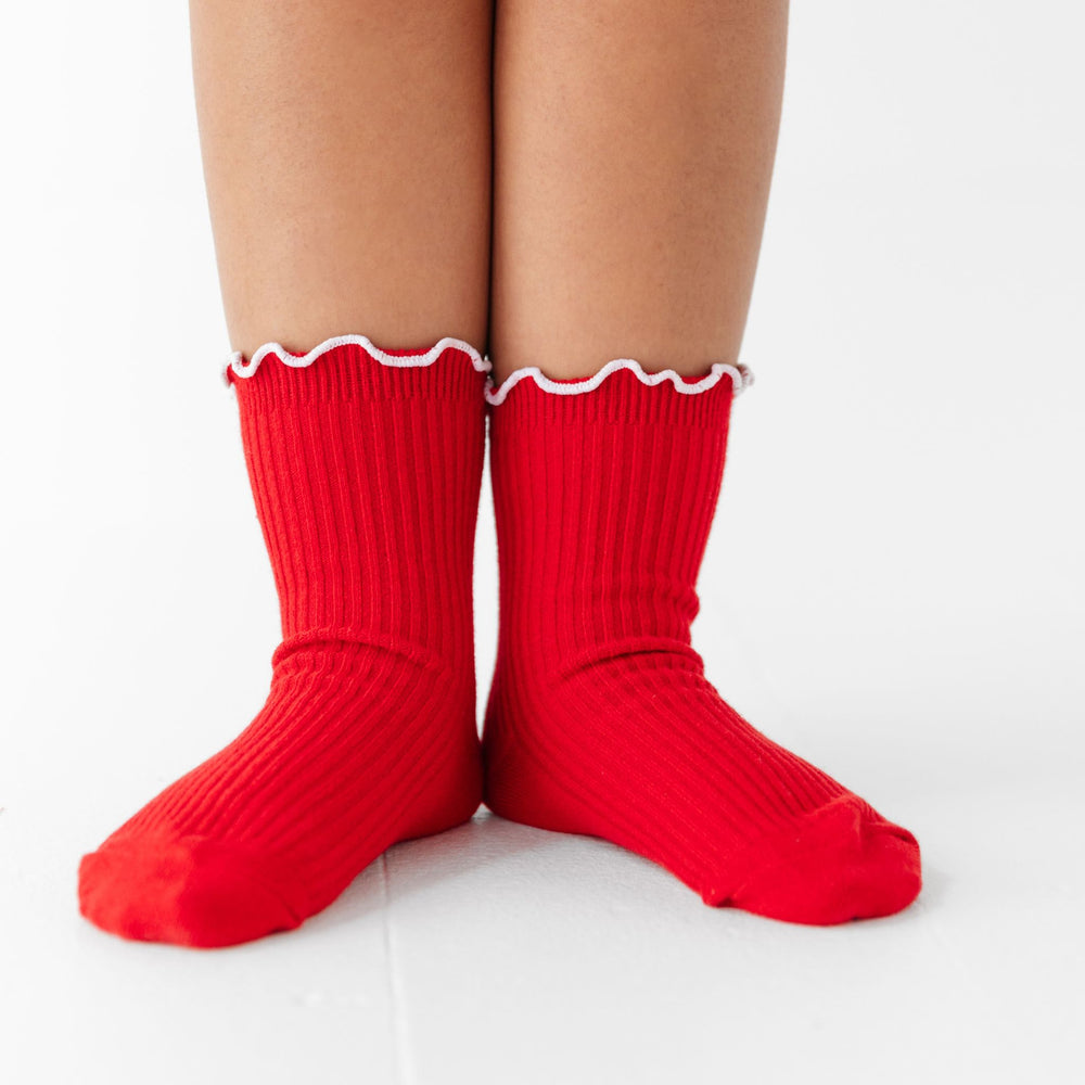 closeup of little girl in bright red ribbed midi socks and white lettuce trim for back to school