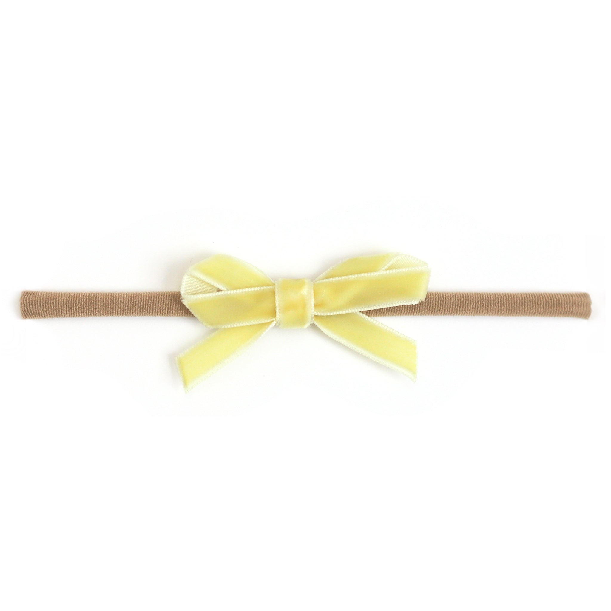 baby girl's pastel yellow velvet ribbon bow on stretchy nylon headband for spring and easter