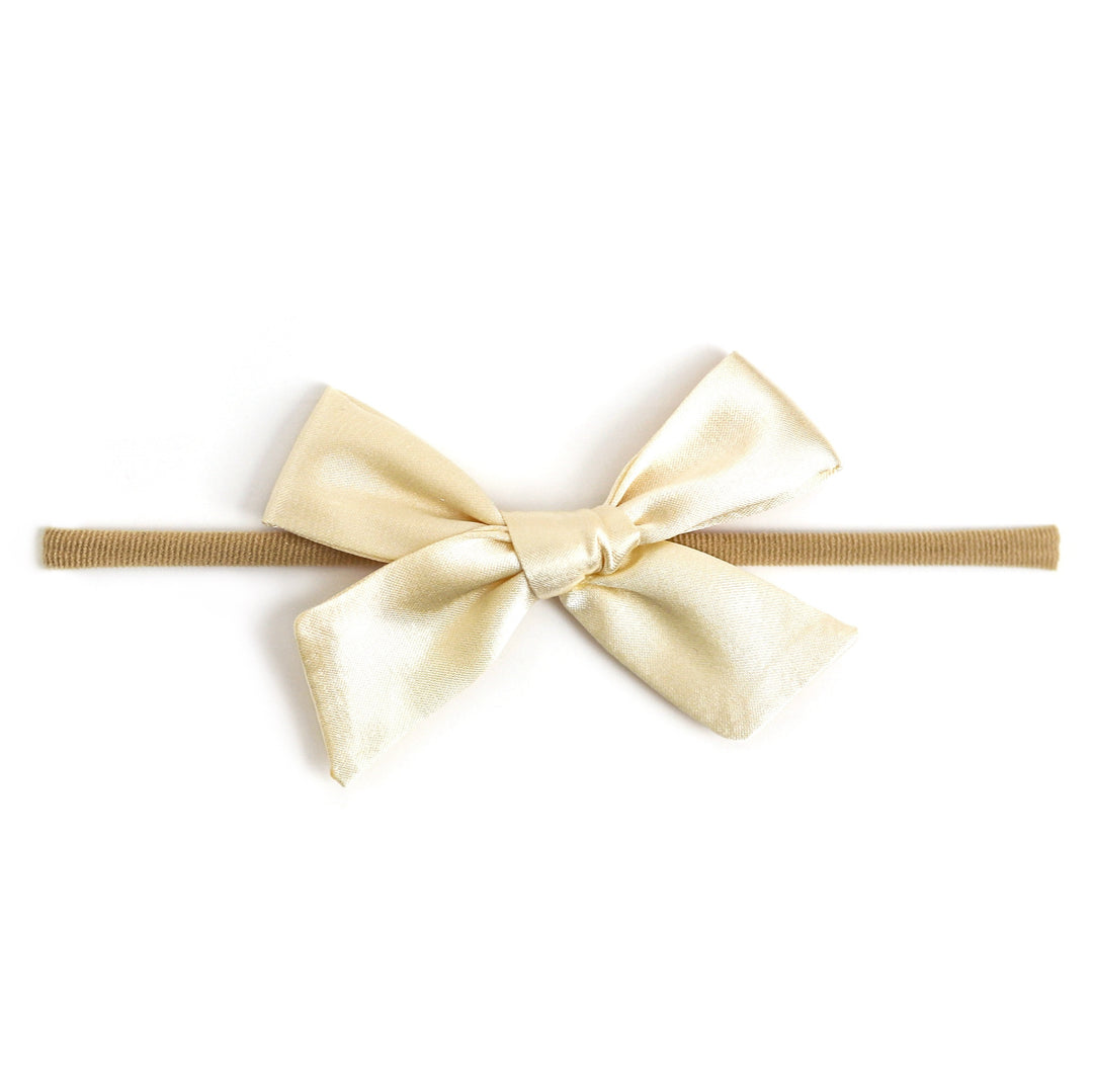cream satin bow on soft nylon band for baby girl