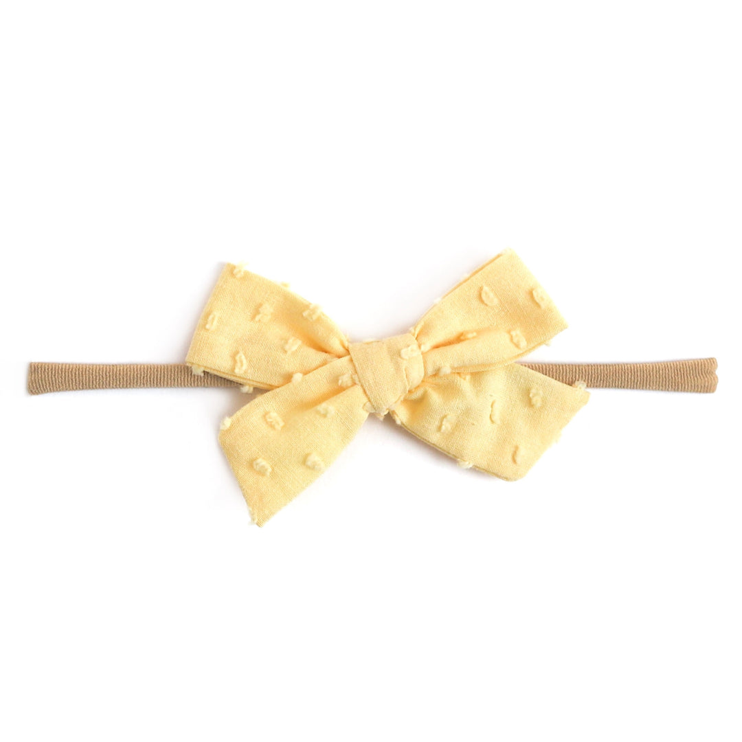 pastel yellow dot baby bow on nylon headband
