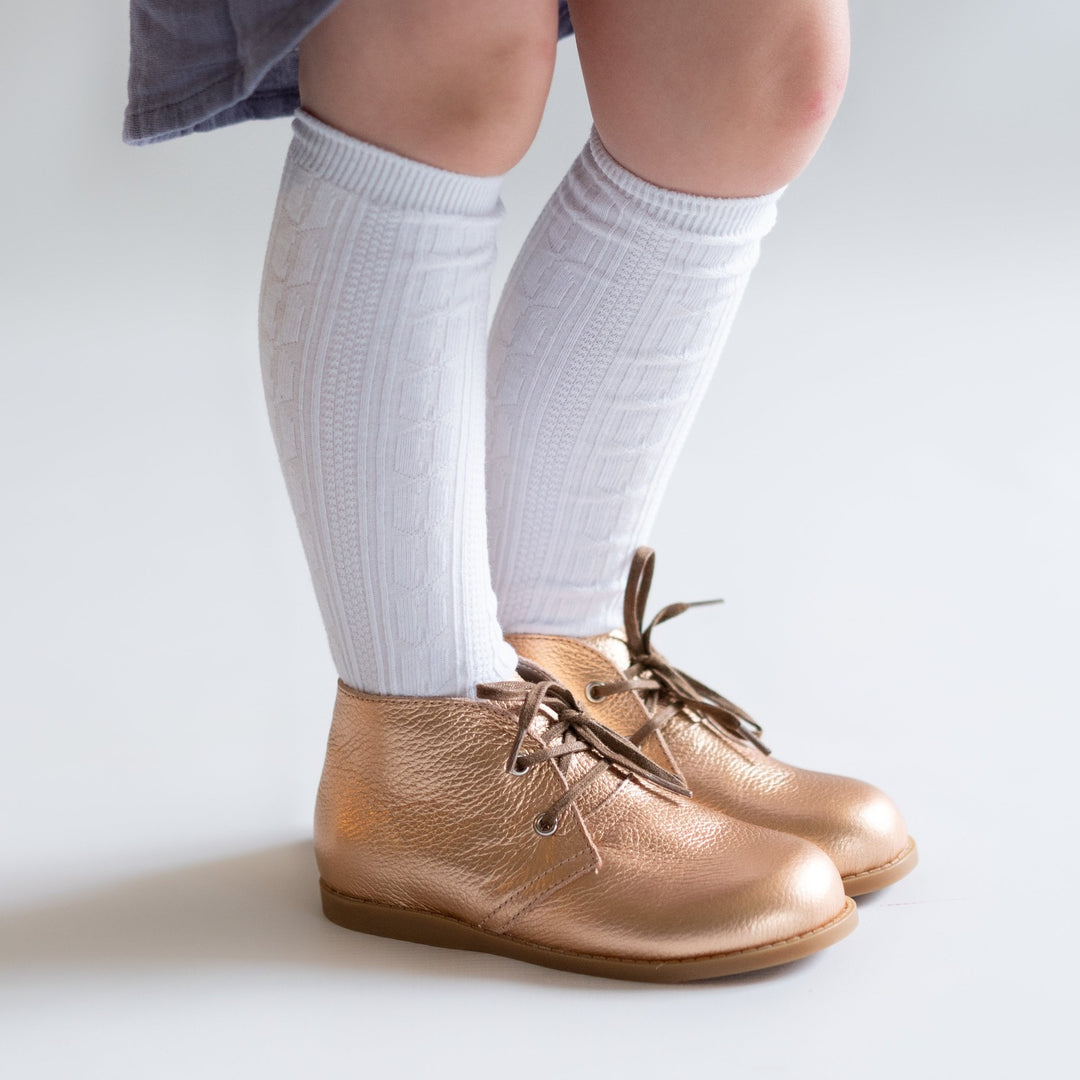 White cable knit knee high socks for babies, toddlers and girls.