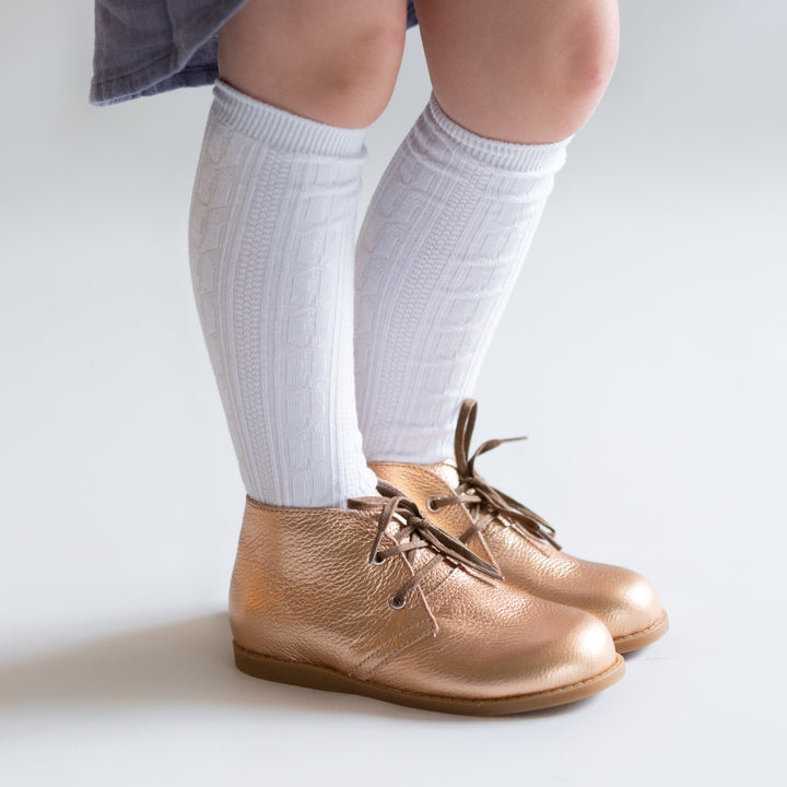 White cable knit knee high socks for babies, toddlers and girls.