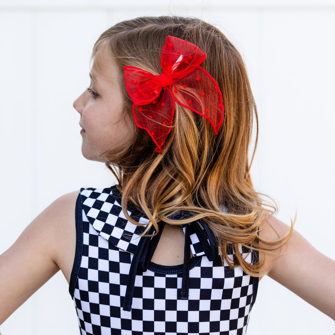 girl wearing large christmas floral print bow