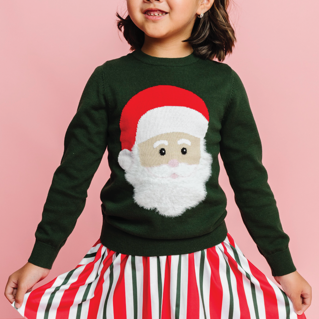 hand embroidered rainbow design knit sweater on little girl in rainbow stripe dress