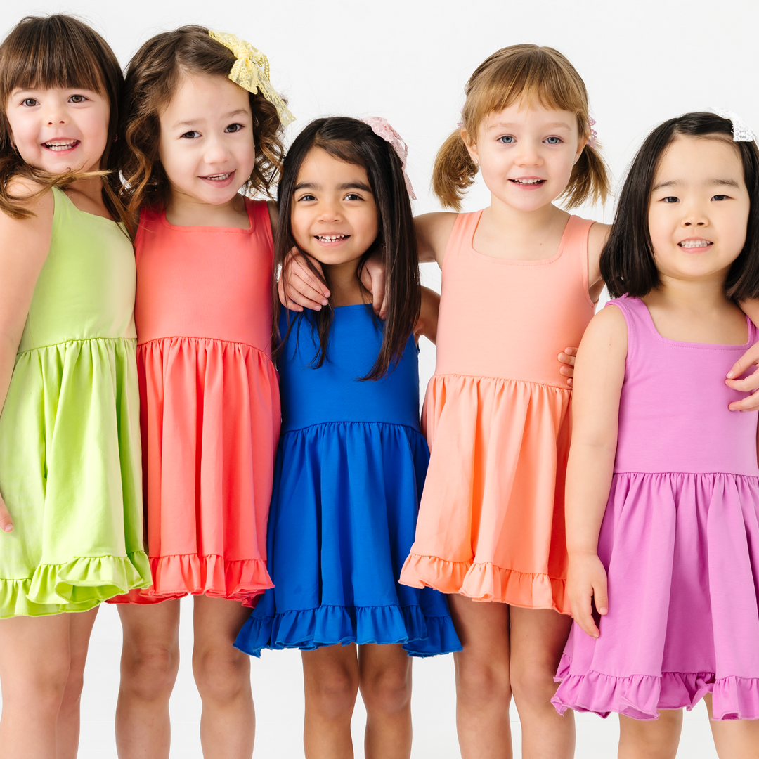 little girl twirling in rainbow heart dress