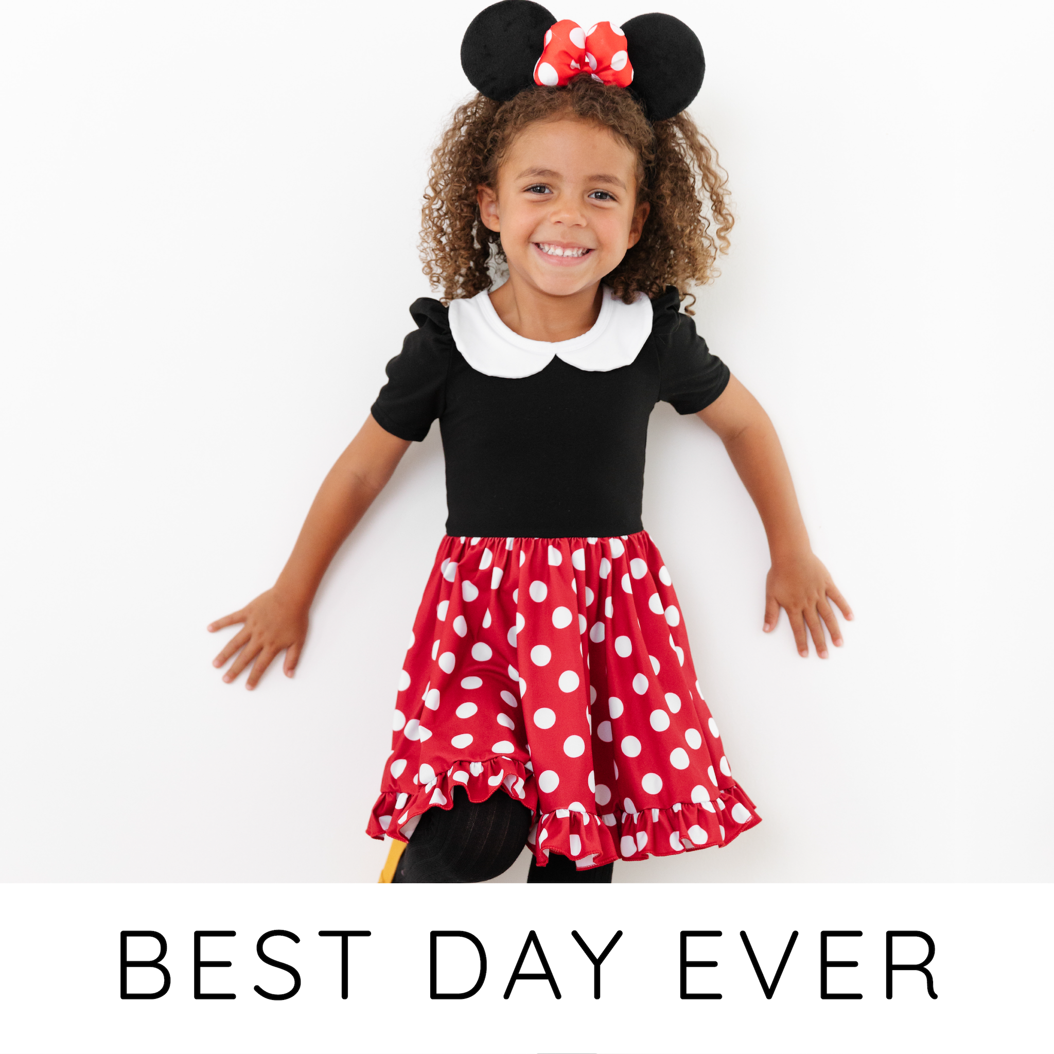 little girl wearing red and white polka dot dress with black bodice and white collar