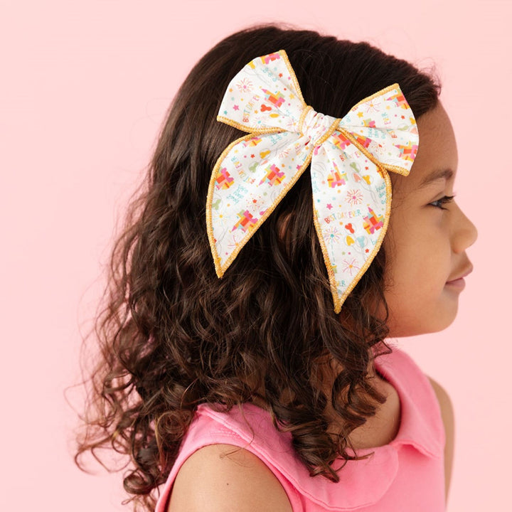 little girls hairbow with disney inspired magical castle print and gold trim