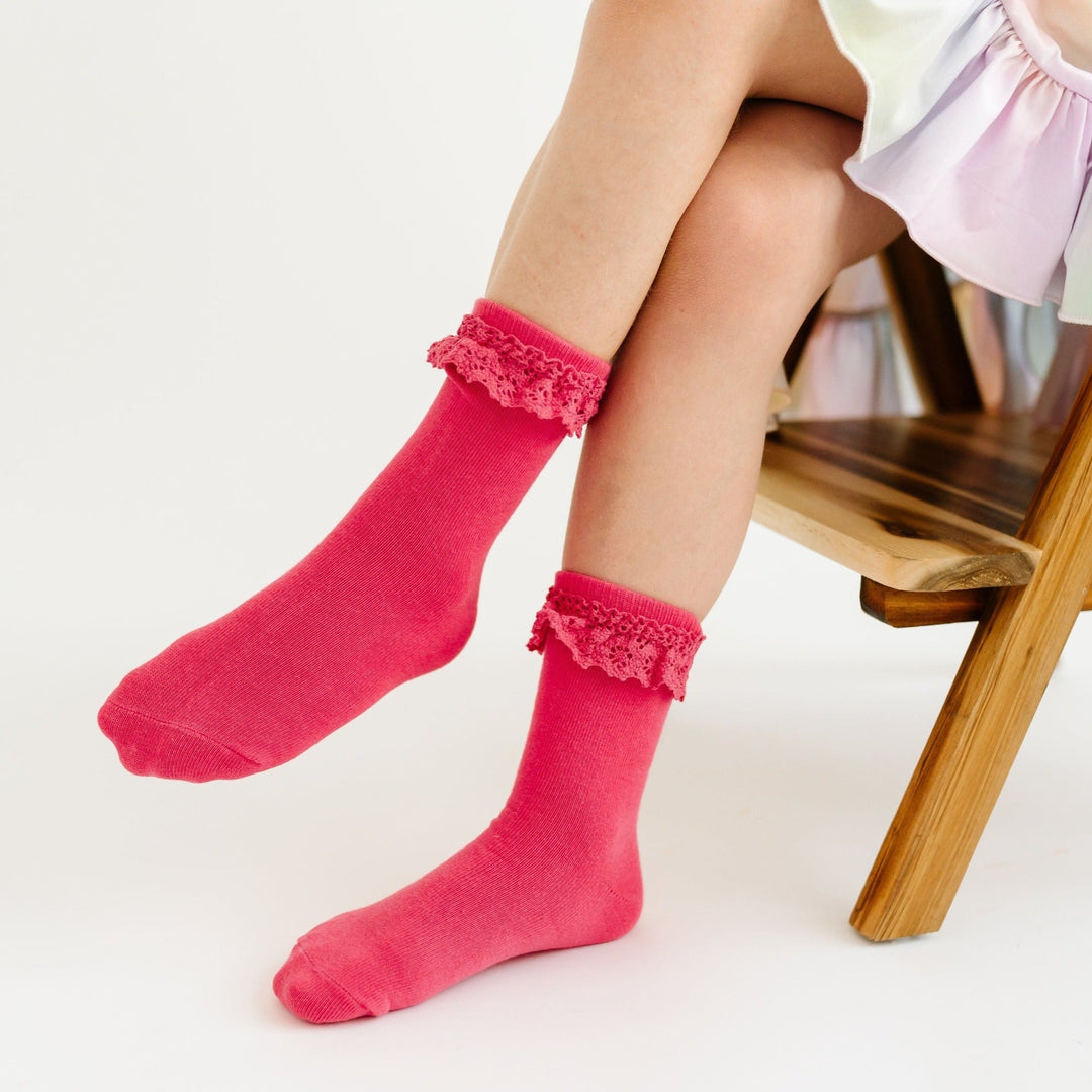 bright hibisucus pink lace midi socks on girl sitting in chair