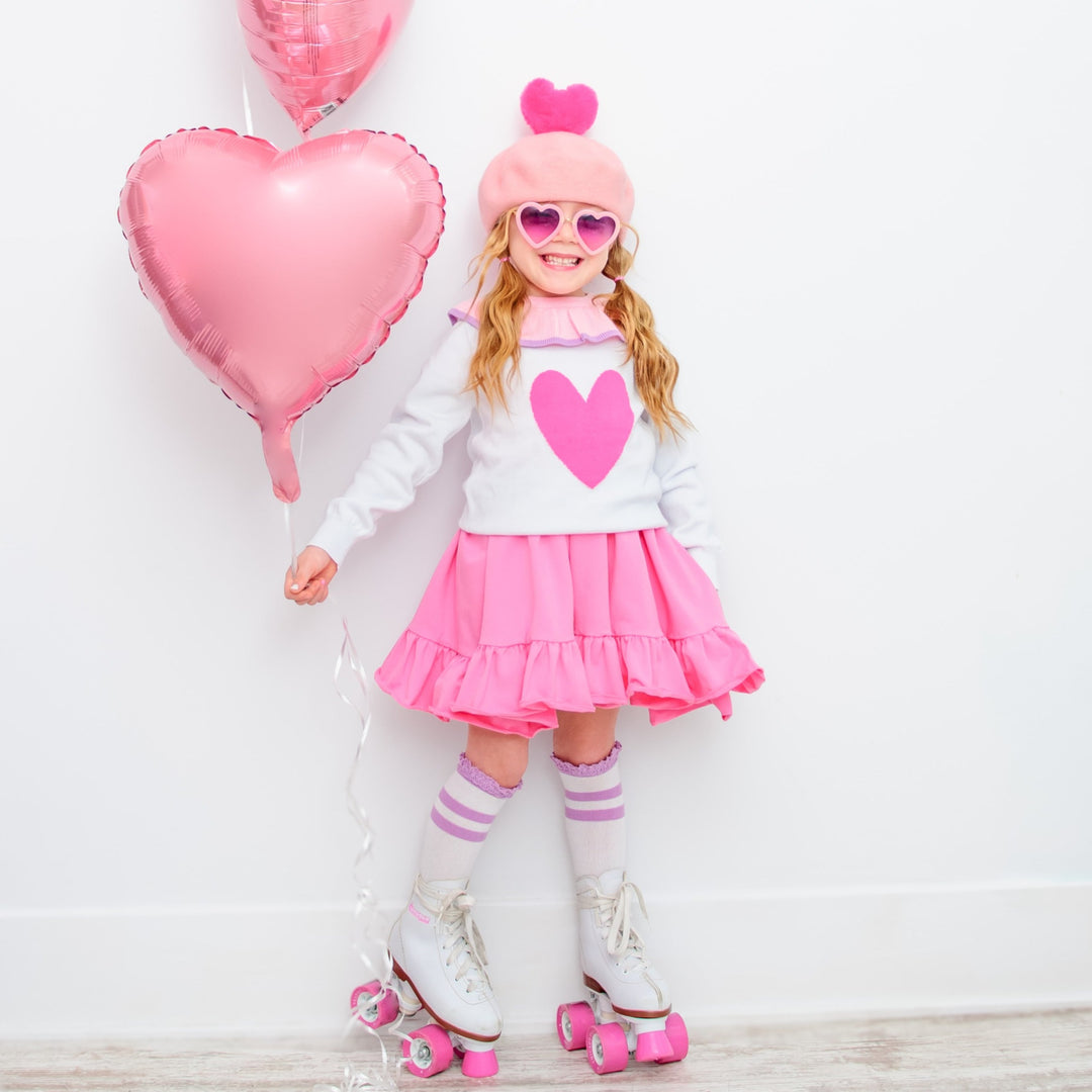 girl wearing valentines outfit with hot pink heart sweater
