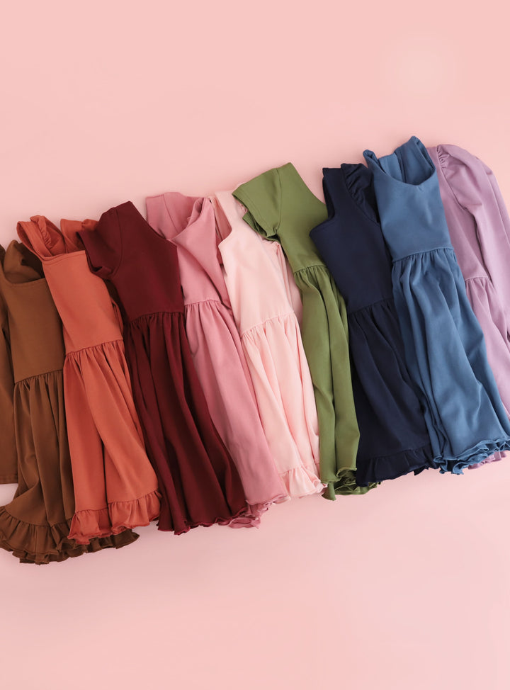 Girls cotton dresses in solid fall colors including brown, rust, burgundy, rose pink, quartz pink, olive green, navy, dusty blue and fall purple