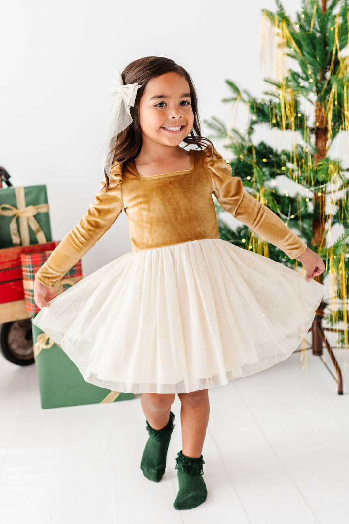 girl wearing fancy gold and cream christmas tutu dress
