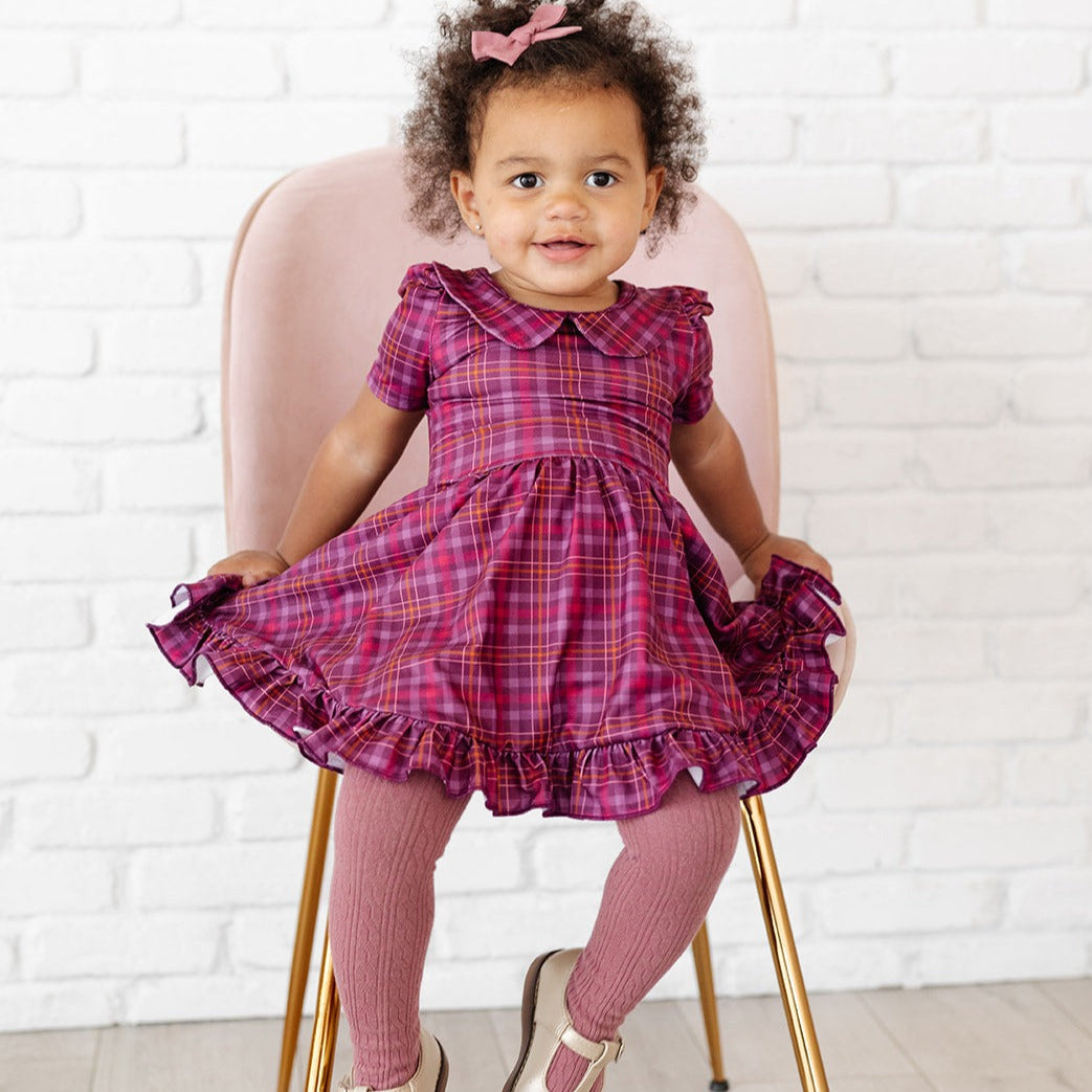 toddler girl wearing mauve cable knit tights with fall plaid dress