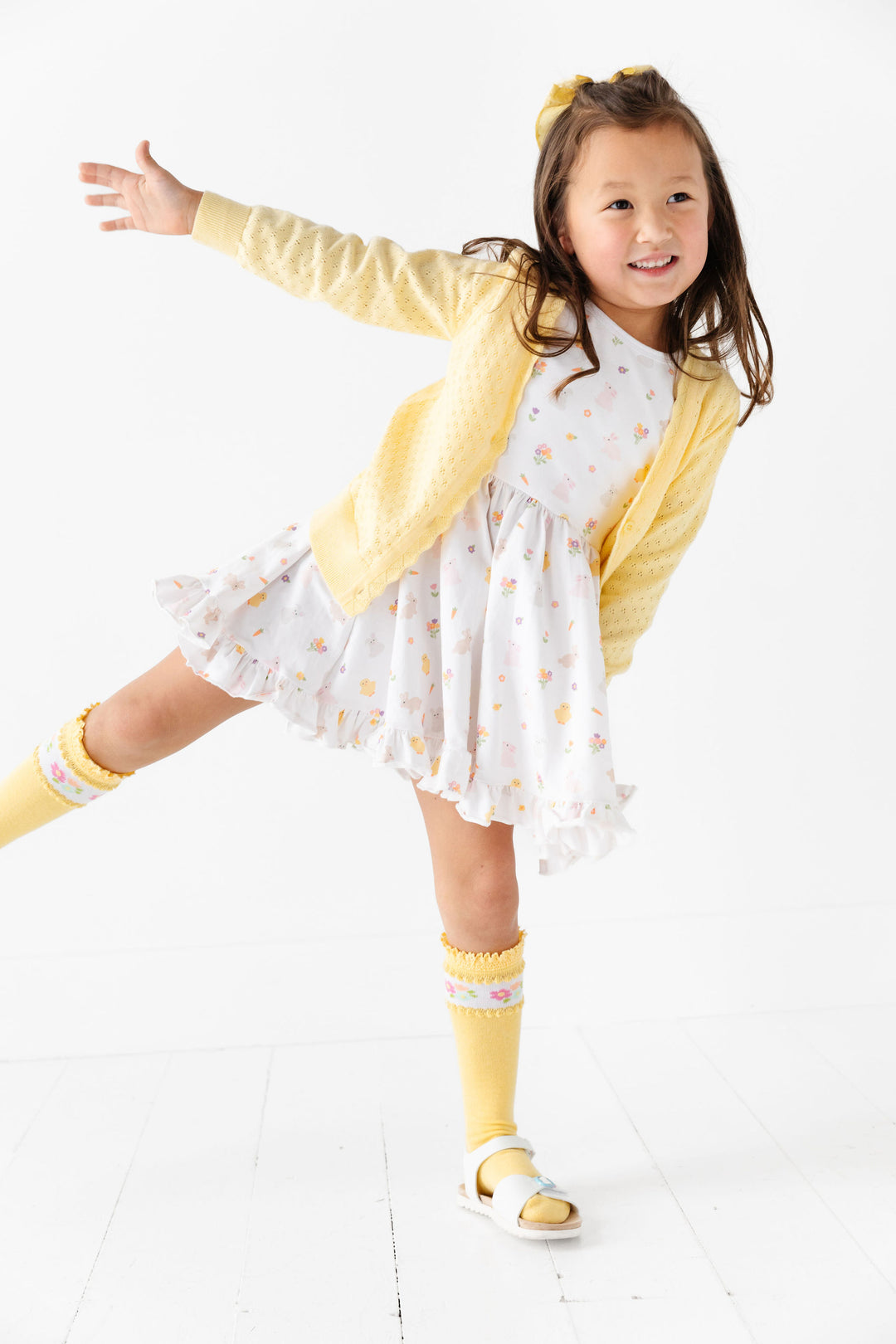 little girl in white easter dress with pointelle yellow cardigan