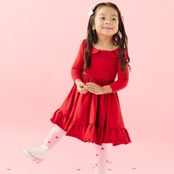 girl in red dress with peter pan collar and valentines day knit tights