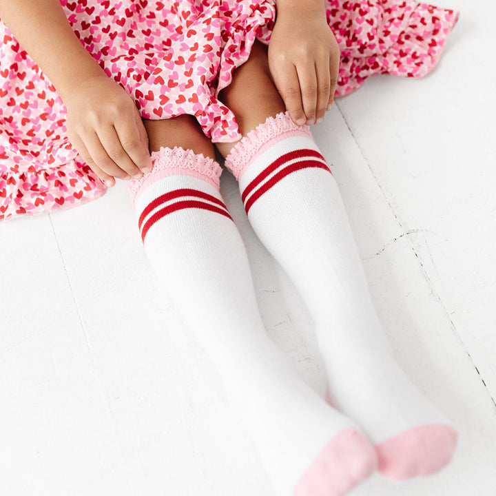 white knee high socks with red stripes and pink lace trim for little girls