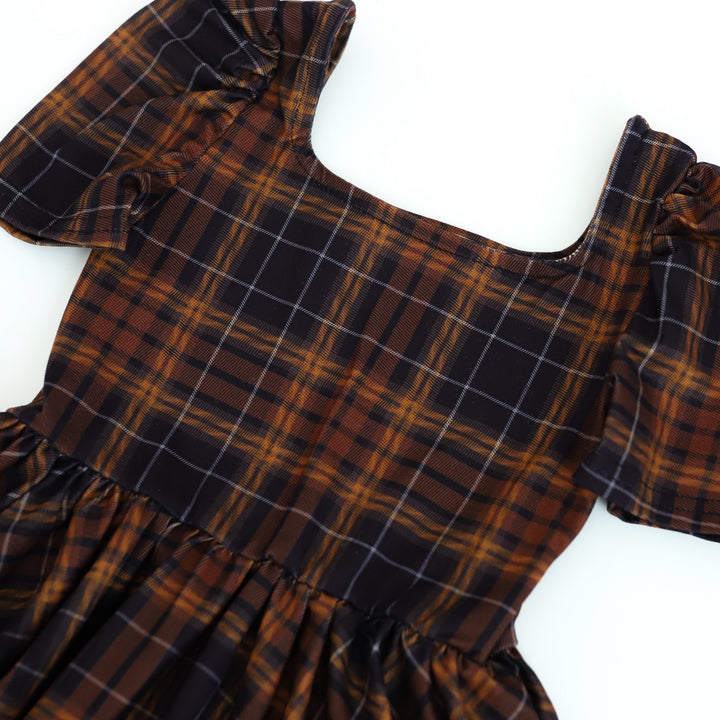 print closeup of girl's harvest twirl dress in black and brown plaid