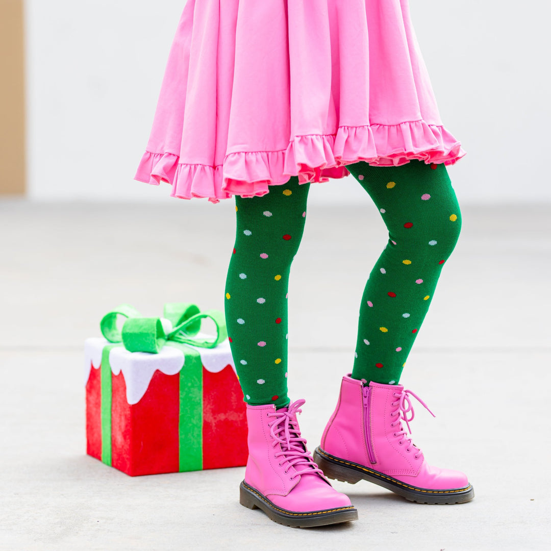 girl in green polkdot Christmas tree tights and pink dress