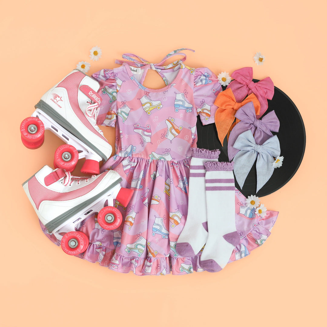 cute girls' roller skating print twirl dress with pockets. shown with cute matching accessories