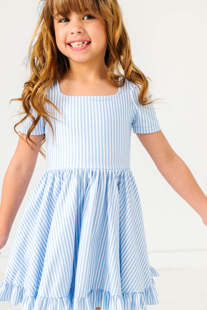girl wearing blue and white pinstripe dress