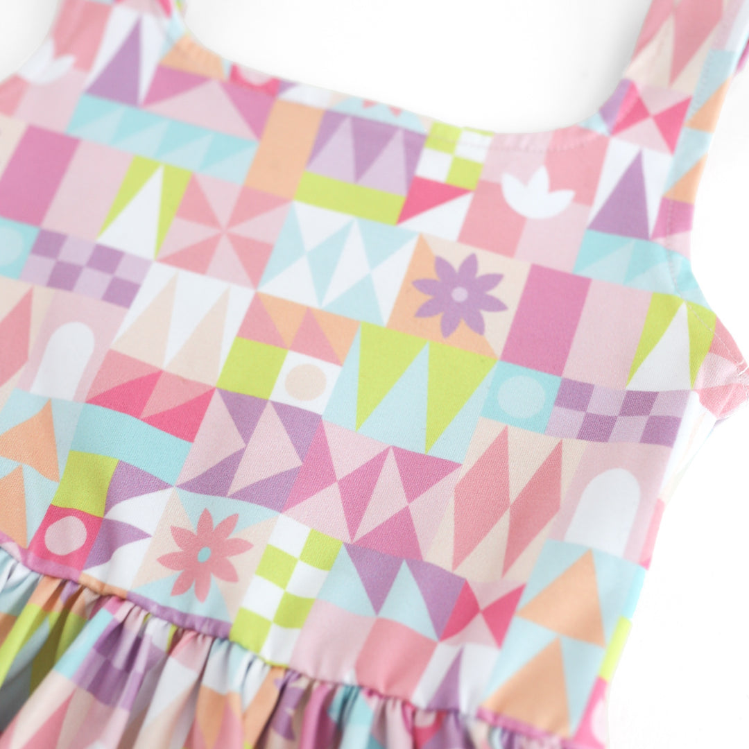 closeup of geometric twirl dress pattern in shades of pink, purple, sky blue and lime green