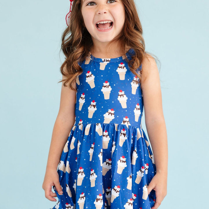 smiling little girl in ice cream cone print summer dress
