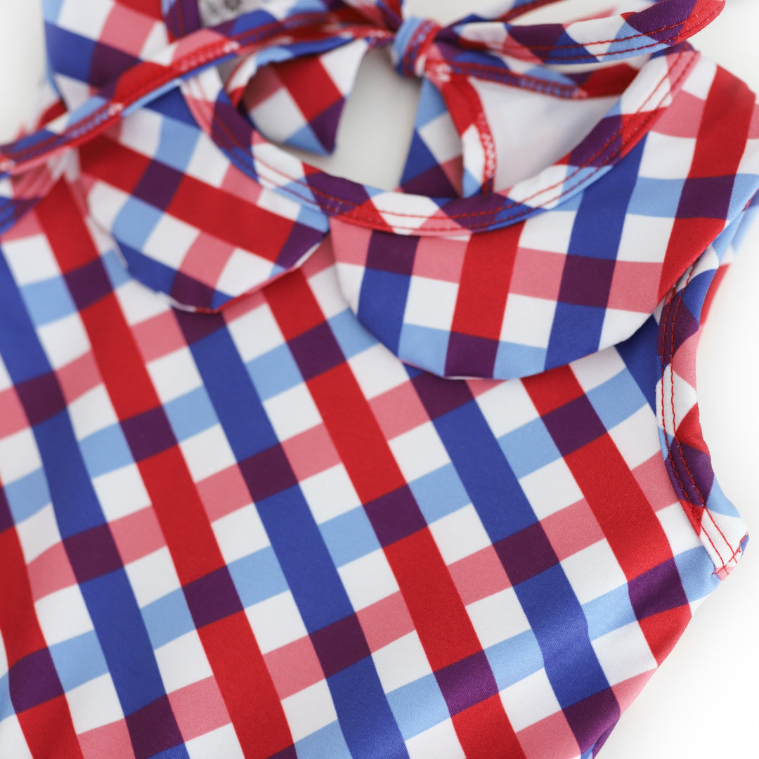 closeup of 4th of July gingham picnic dress with shades of red, white and blue