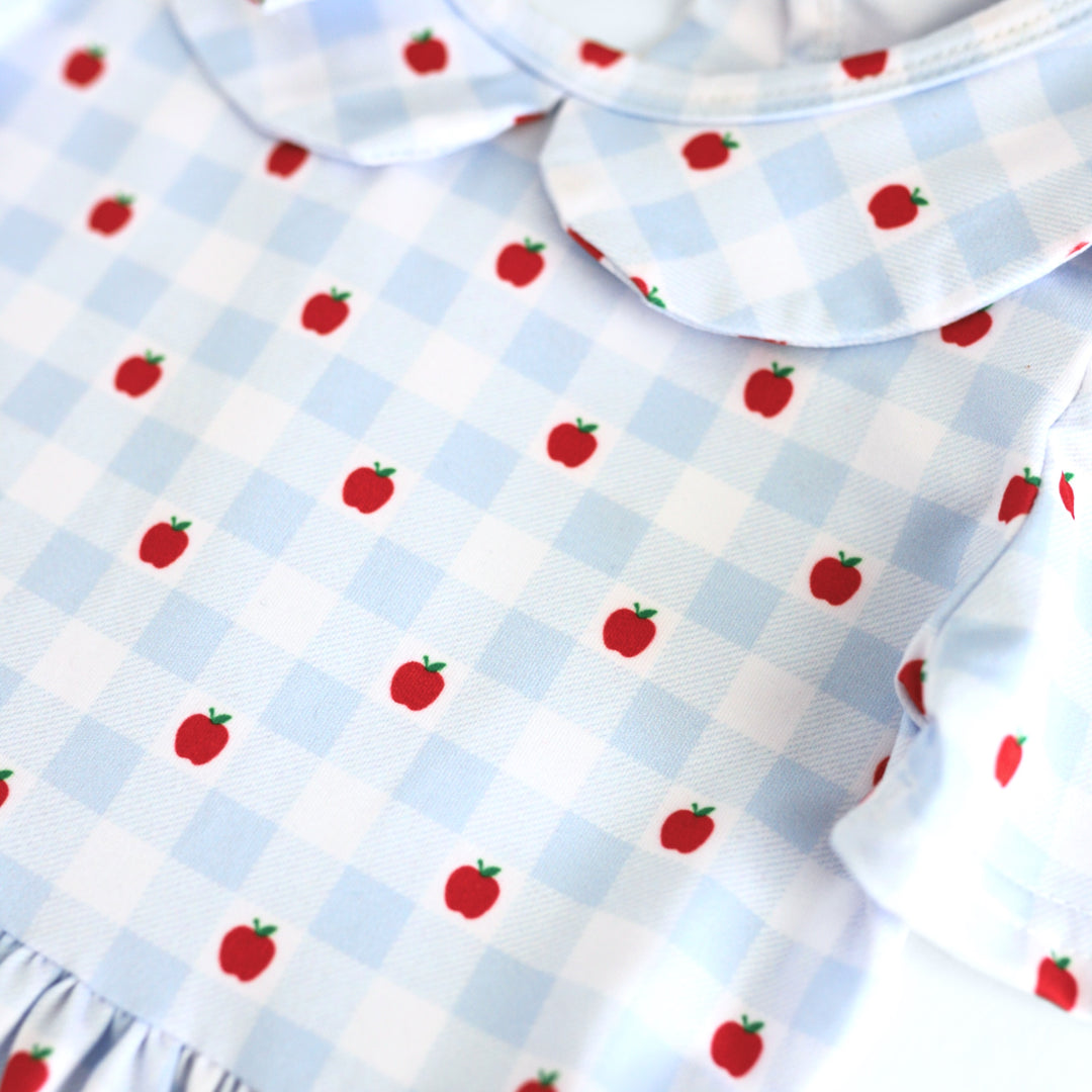 closeup of girls' light blue and white with petite apple print dress bodice for back to school and apple picking season