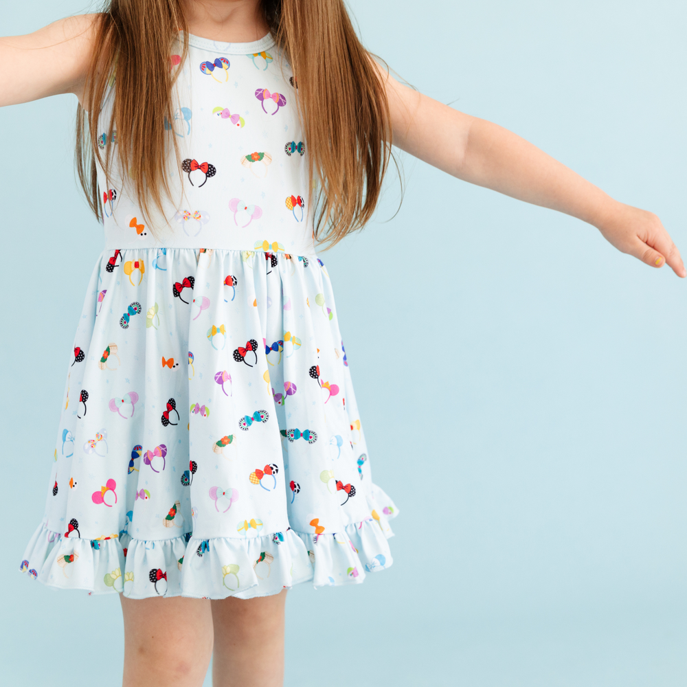little girl wearing light blue mouse ear twirl dress